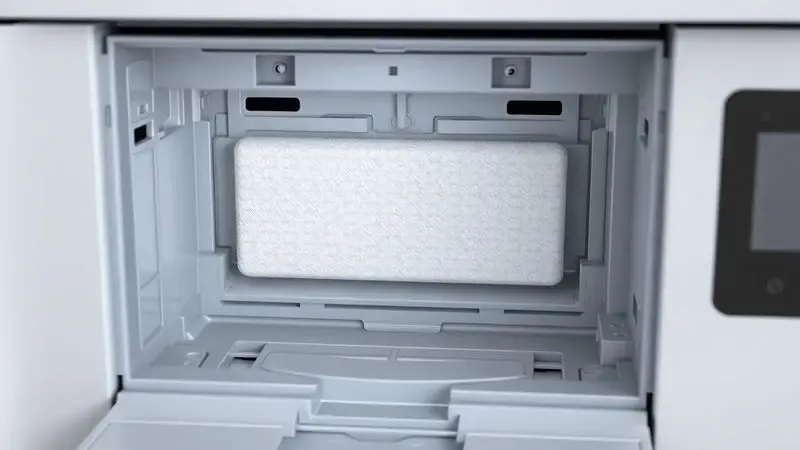 Ilustração 3D dos componentes internos de uma impressora mostrando o compartimento de absorção de tinta de forma genérica.